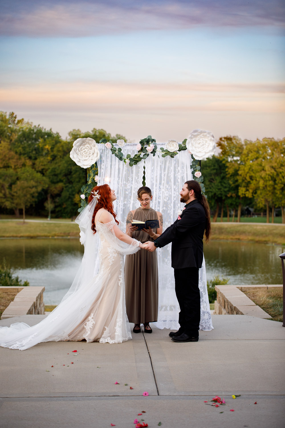 A bride and groom stand at the alter of an outdoor wedding ceremony in Kansas City.